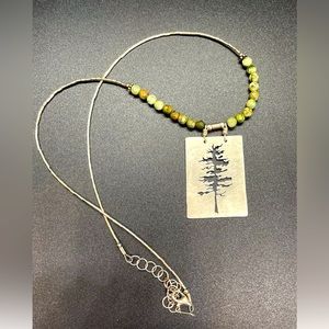 Artisan made silver necklace with tree pendant